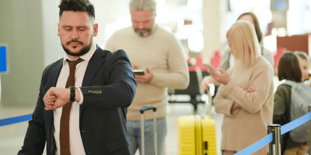 man in a professional dress checking time on watch